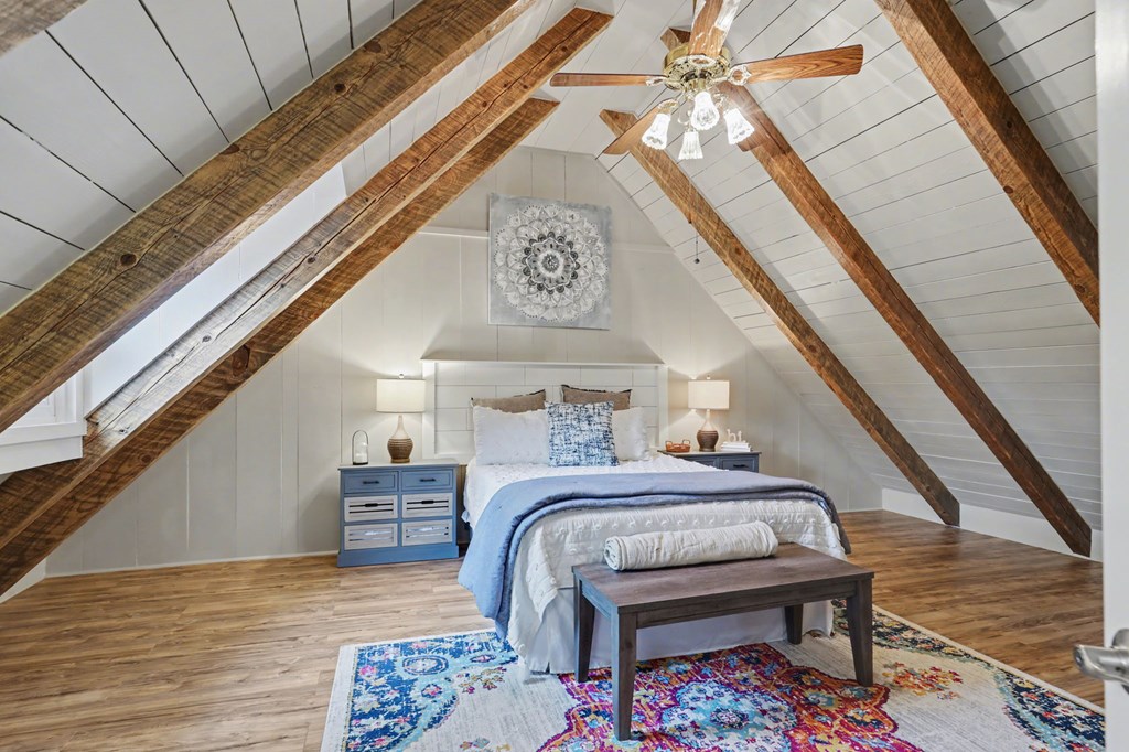 4609 Matheson Road Hiawassee, GA 30546 - Photo 37 of 57 a bedroom with a bed a chandelier and dresser