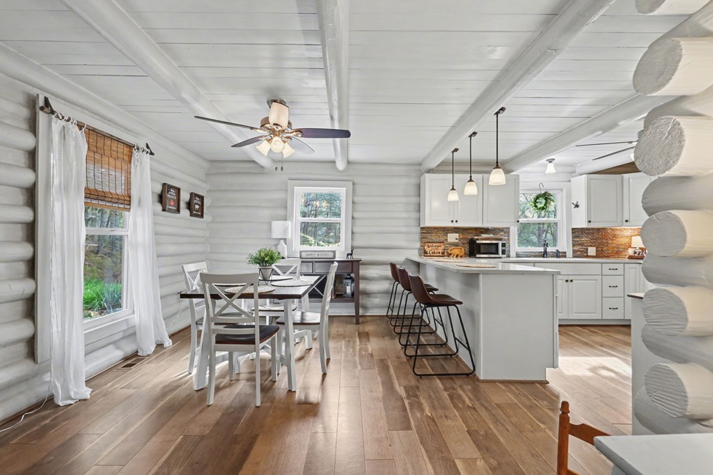4609 Matheson Road Hiawassee, GA 30546 - Photo 10 of 57 a kitchen with stainless steel appliances a dining table chairs stove and wooden floor