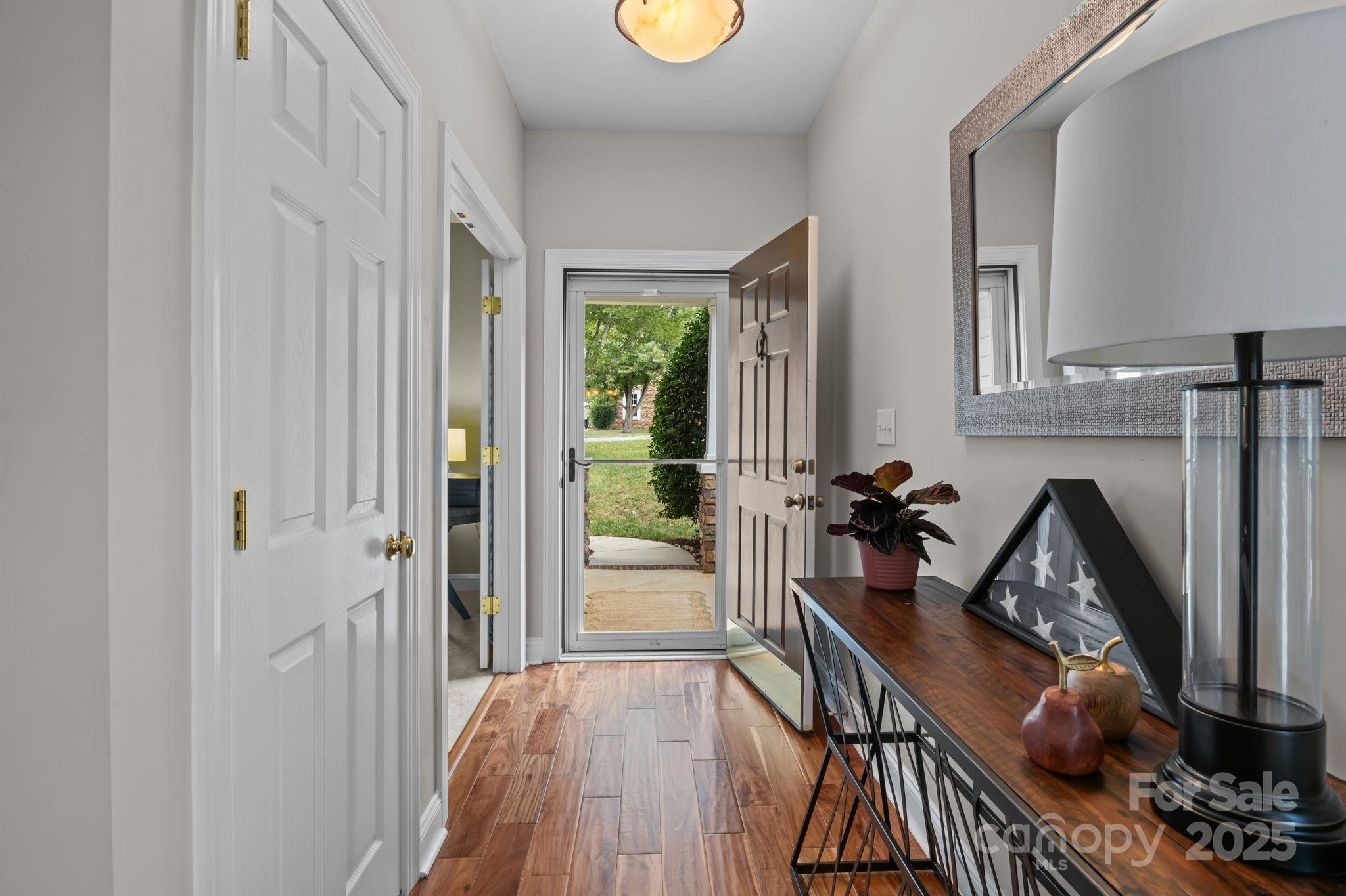 802 Seipel Drive Denver, NC 28037 - Photo 11 of 35 a view of a hallway to a livingroom with furniture wooden floor and window