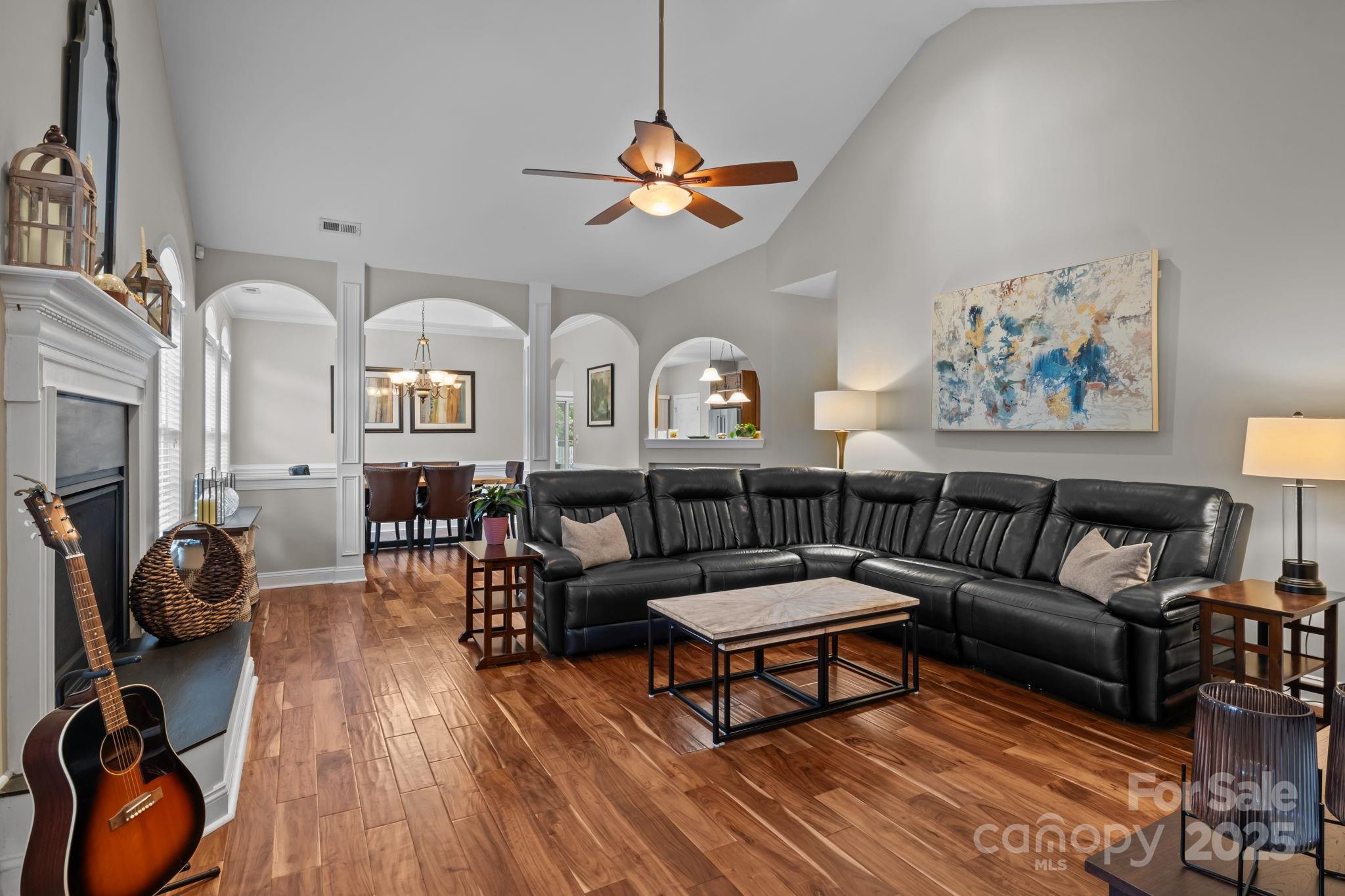 802 Seipel Drive Denver, NC 28037 - Photo 16 of 35 a living room with furniture a fireplace and a chandelier
