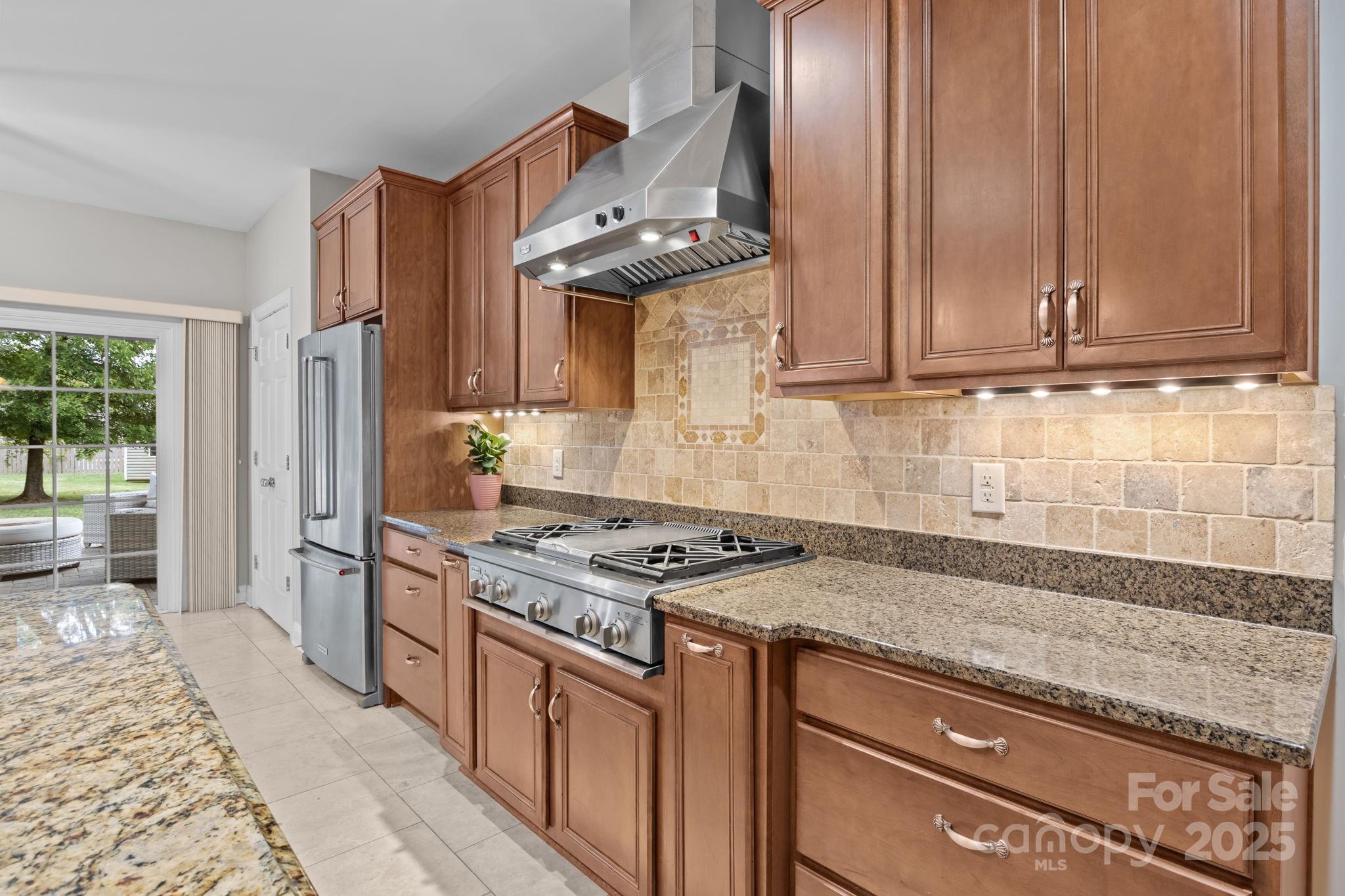 802 Seipel Drive Denver, NC 28037 - Photo 25 of 35 a kitchen with stainless steel appliances granite countertop a stove a sink and a refrigerator