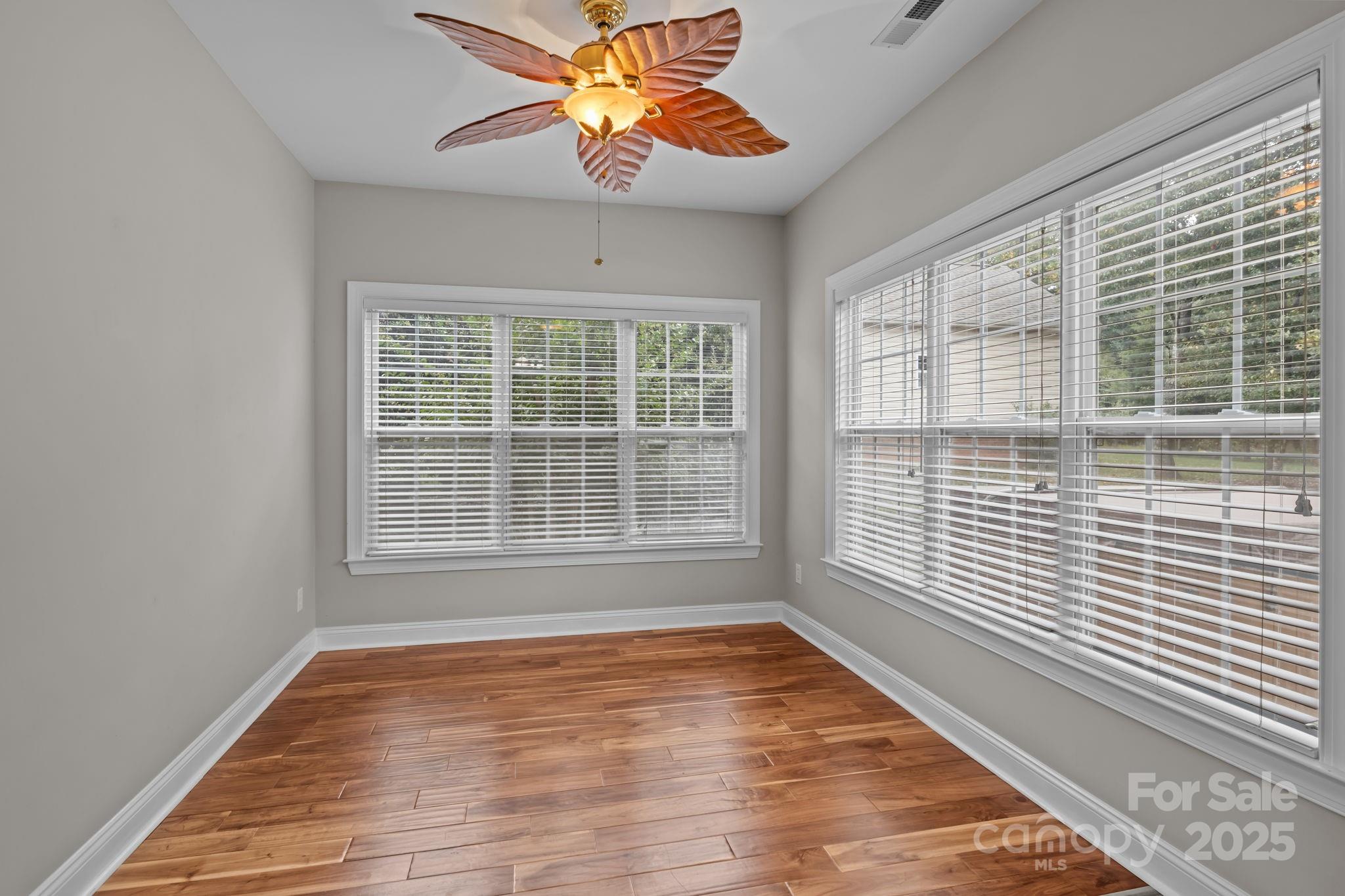 802 Seipel Drive Denver, NC 28037 - Photo 28 of 35 a view of an empty room with wooden floor and a window