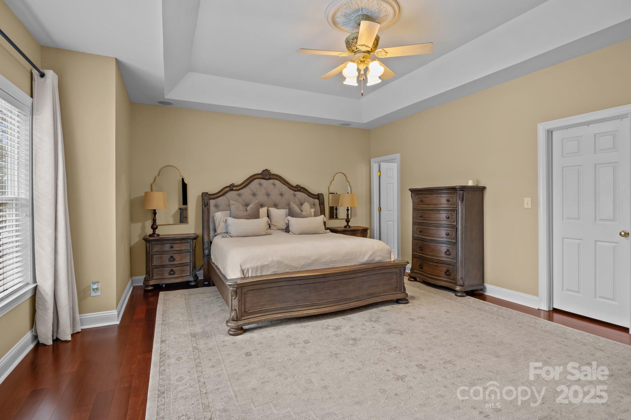 802 Seipel Drive Denver, NC 28037 - Photo 31 of 35 a bedroom with a bed and a chandelier