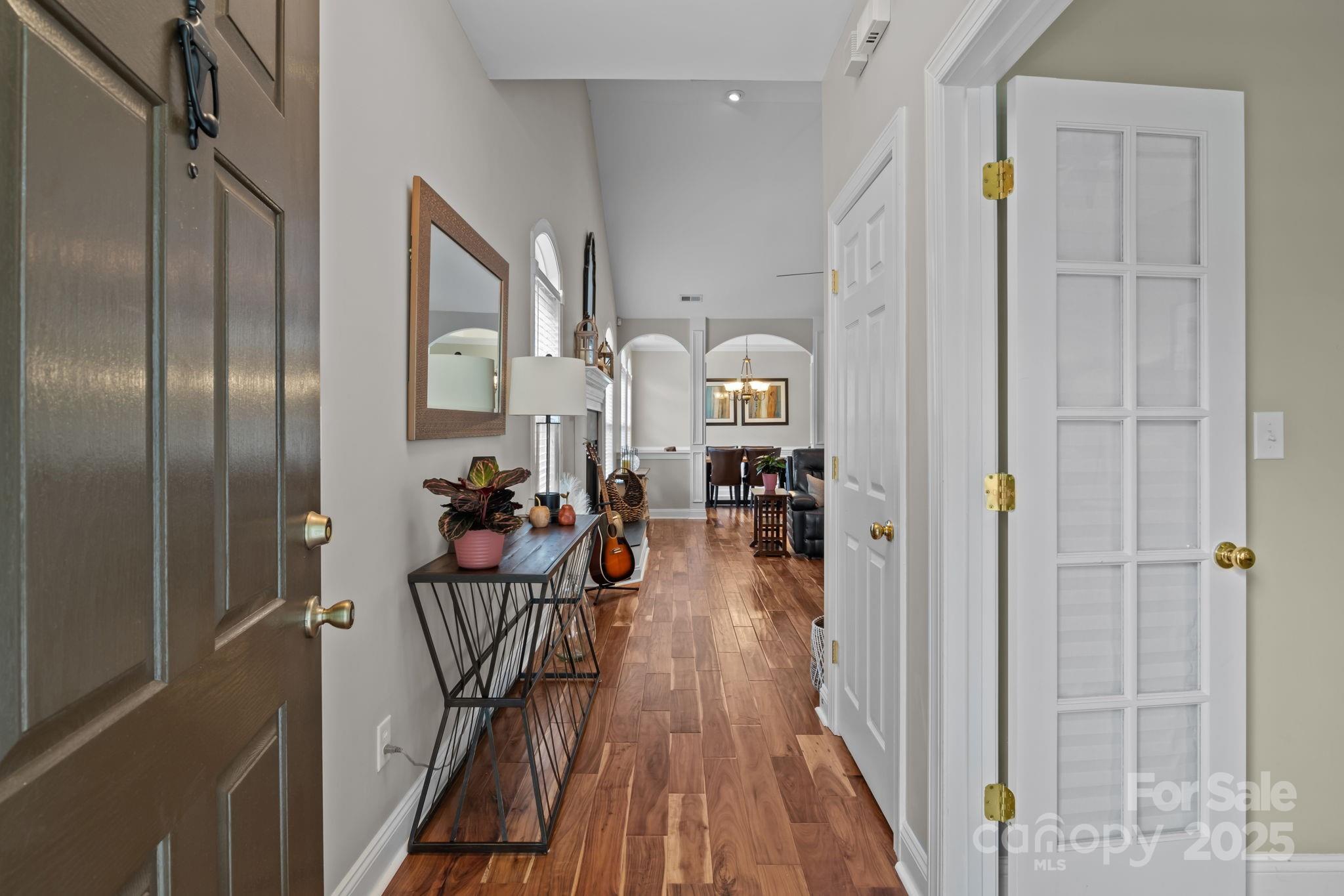 802 Seipel Drive Denver, NC 28037 - Photo 10 of 35 a view of a hallway with wooden floor fireplace and living room