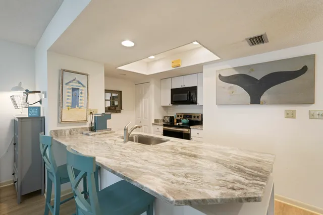 a kitchen with stainless steel appliances granite countertop a sink and stove