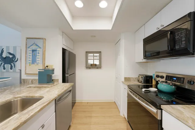 a kitchen with granite countertop a table and chairs in it