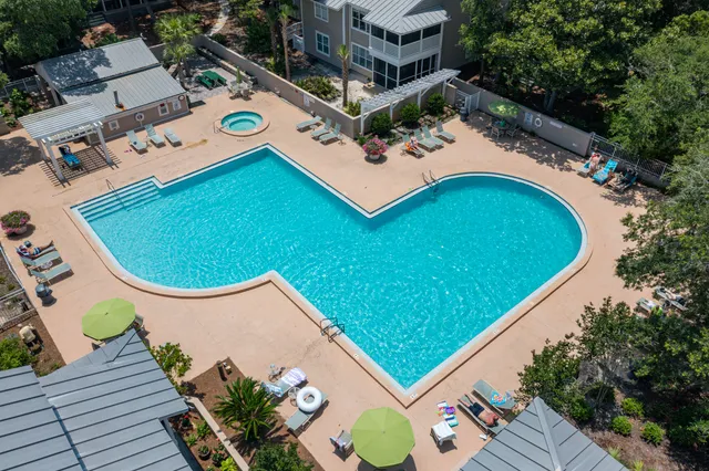 a bathroom with a toilet a sink a mirror a vanity and shower