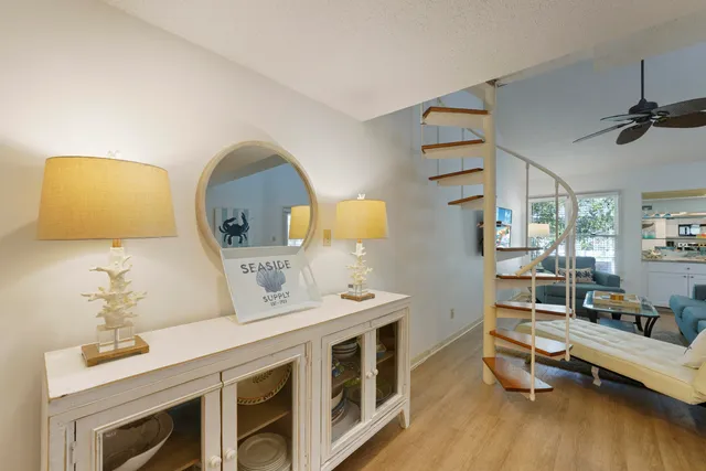 a living room with a bed furniture and a wooden floor