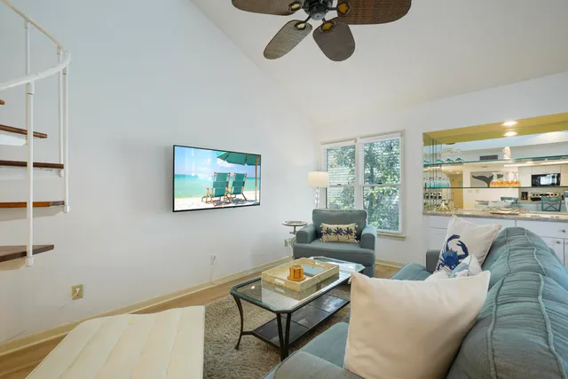 a living room with furniture and a floor to ceiling window