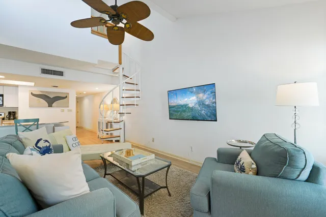 a living room with furniture and a chandelier
