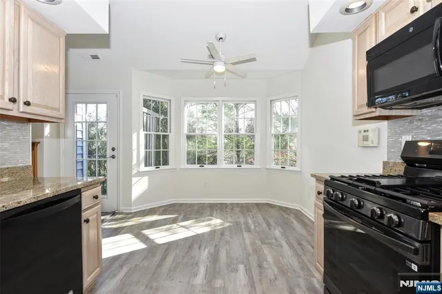 a kitchen with a stove a sink and a window