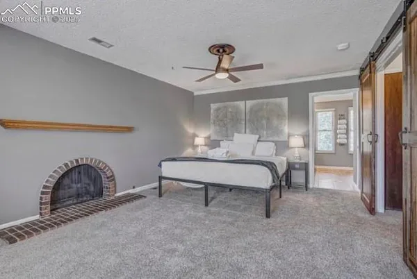 a bedroom with a bed and a fireplace