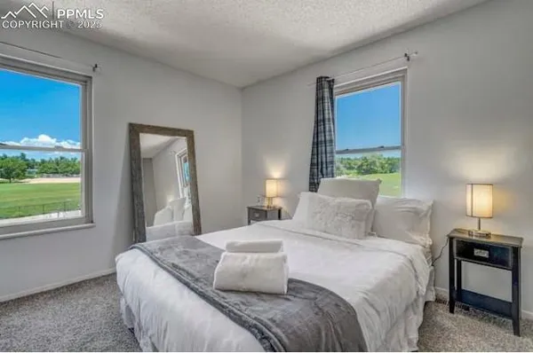 a bedroom with a bed and a mirror