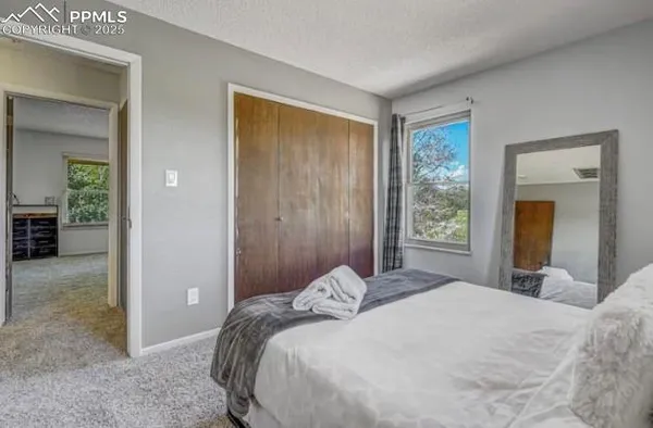 a bedroom with a large bed and a chandelier