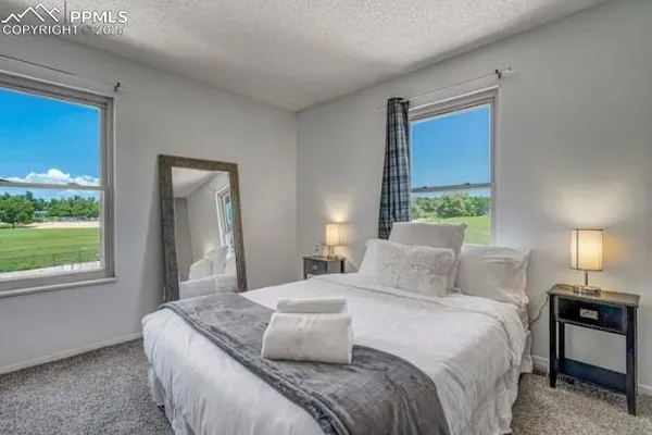 a bedroom with a bed and a mirror