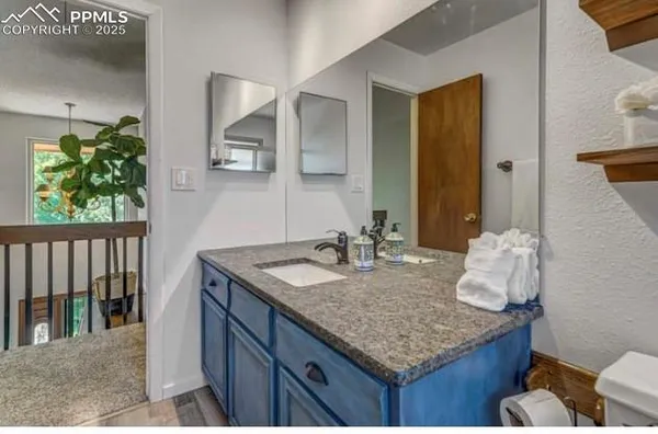 a view of entryway with furniture and wooden floor