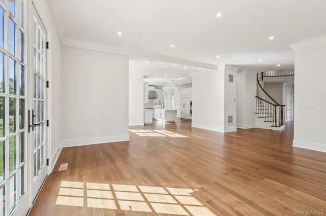 a view of empty room with wooden floor