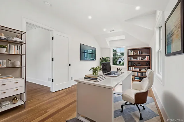 a dining room with furniture and wooden floor