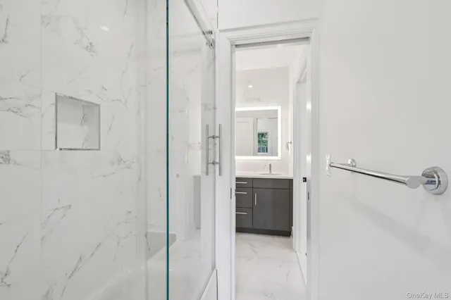 a bathroom with a granite countertop shower mirror and a sink