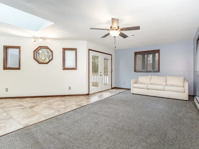 a view of livingroom with furniture and fan