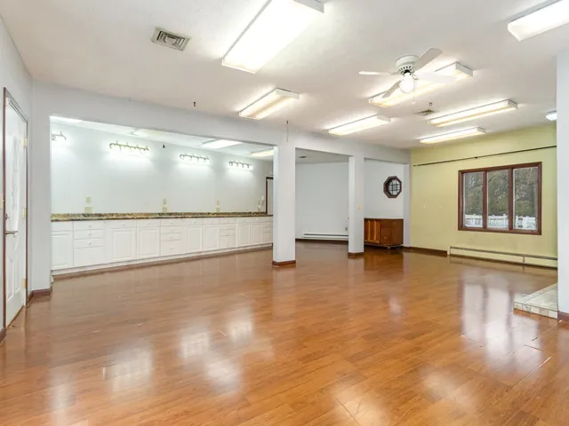 a view of a kitchen with a stove cabinets and wooden floor