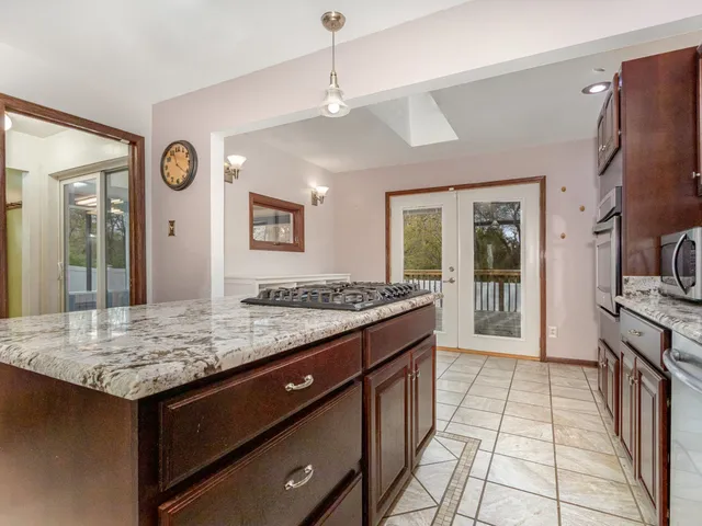a spacious bathroom with a granite countertop sink and a mirror