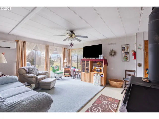 a bedroom with furniture and a flat screen tv