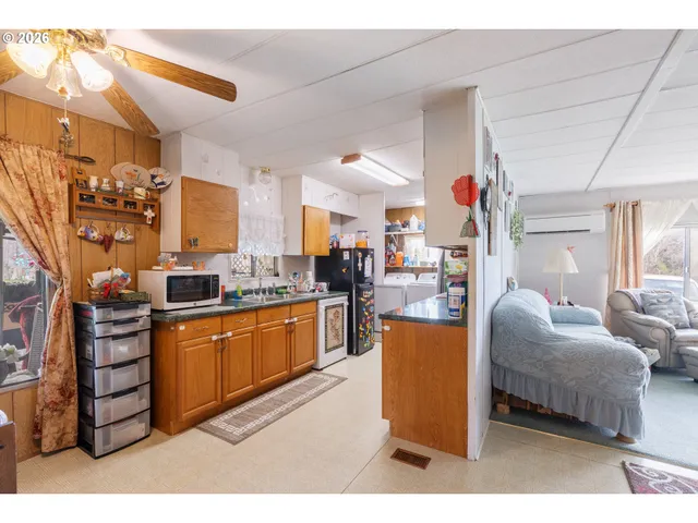 a living room with furniture and a kitchen
