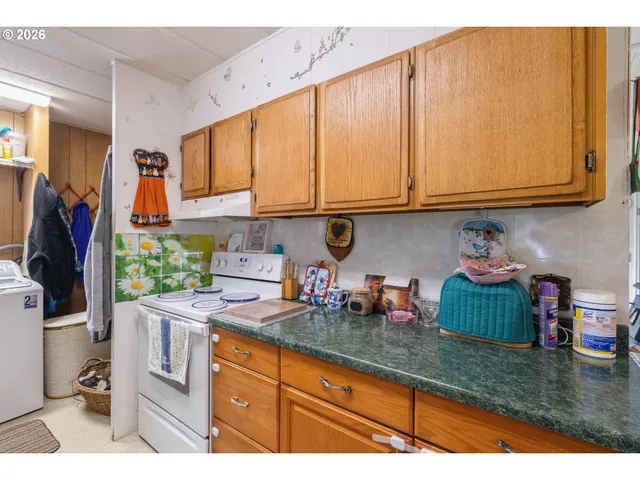 a kitchen with stainless steel appliances granite countertop a sink dishwasher stove and cabinets