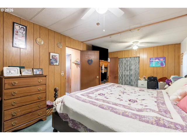 a bedroom with a bed and a dresser