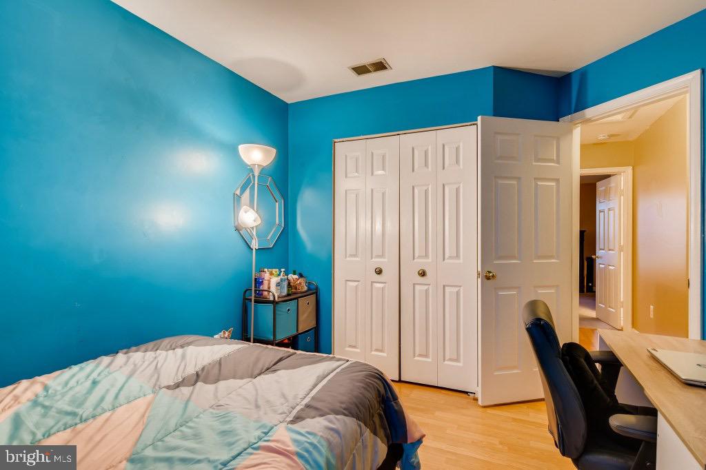 7410 Maury Road Windsor Mill, MD 21244 - Photo 21 of 28 a bedroom with a bed and a chandelier