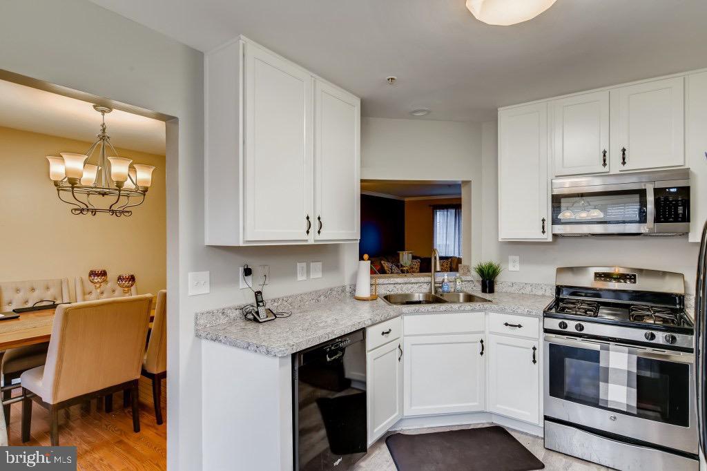 7410 Maury Road Windsor Mill, MD 21244 - Photo 8 of 28 a kitchen with a sink cabinets and appliances