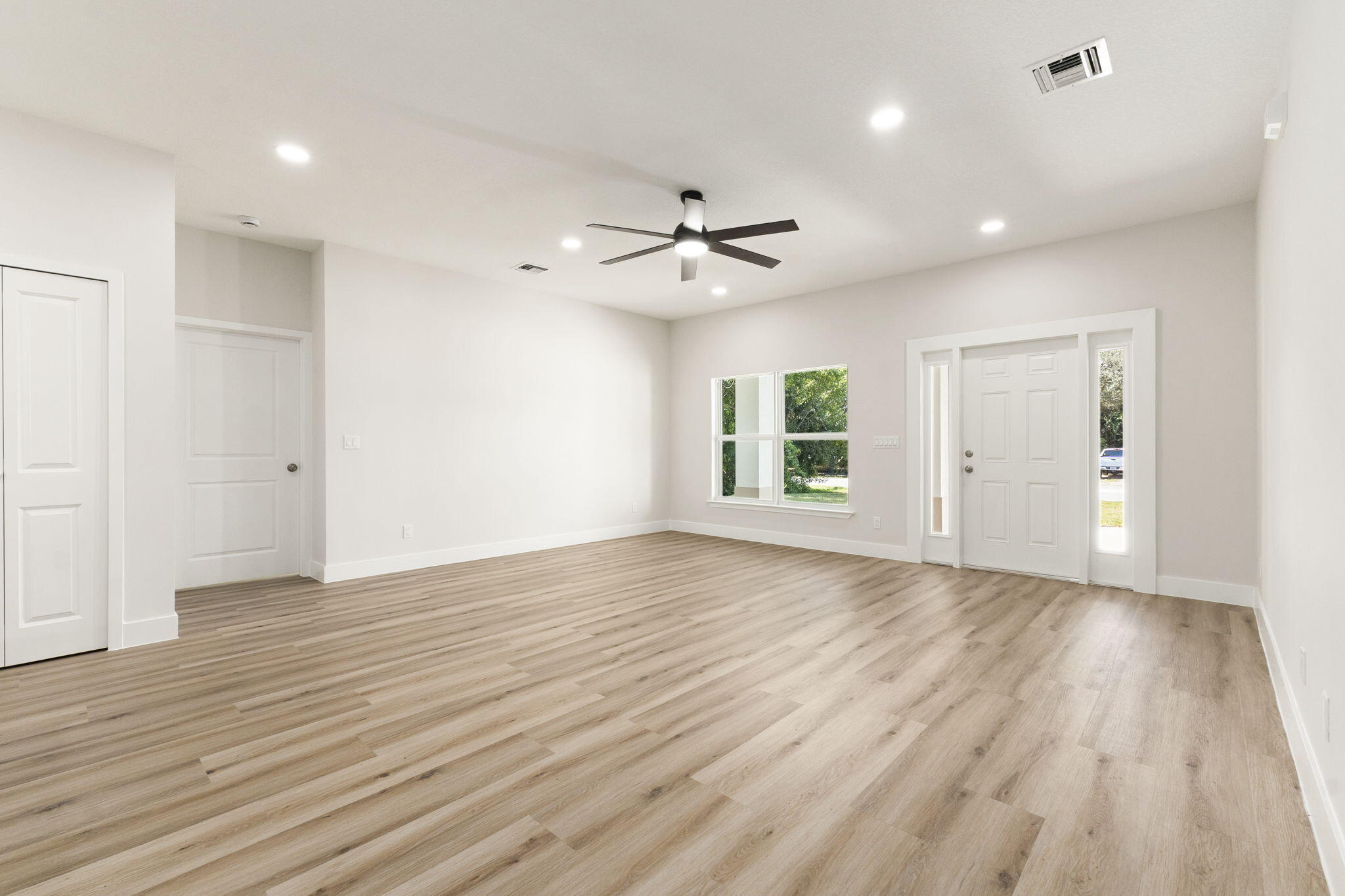 5310 Sunset Boulevard Fort Pierce, FL 34982 - Photo 12 of 39 an empty room with wooden floor and windows
