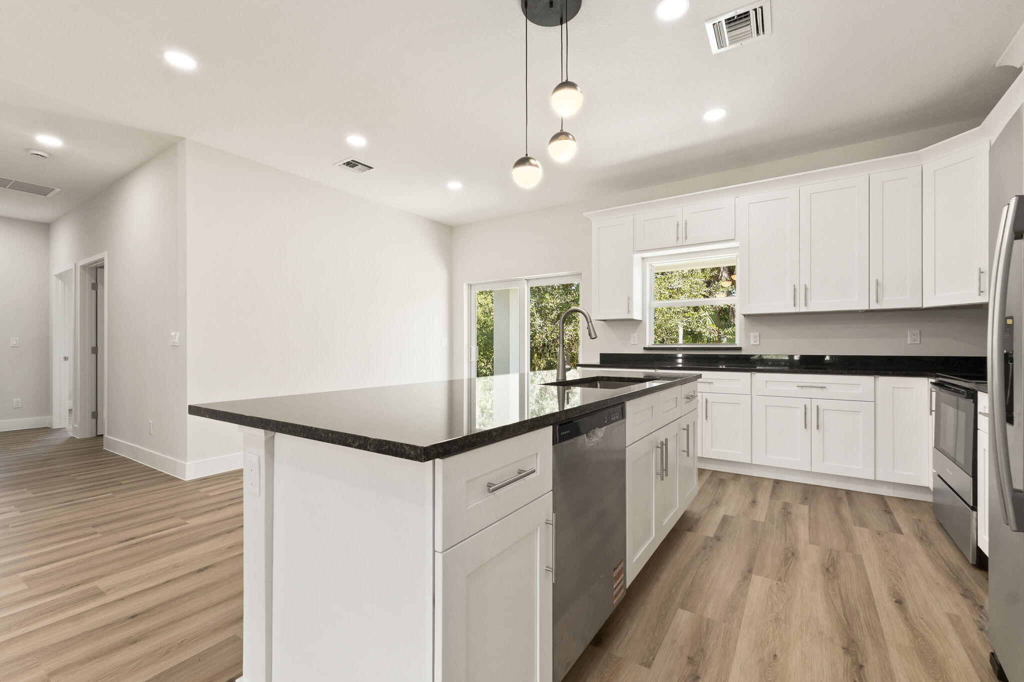 5310 Sunset Boulevard Fort Pierce, FL 34982 - Photo 14 of 39 a kitchen with granite countertop white cabinets and white appliances
