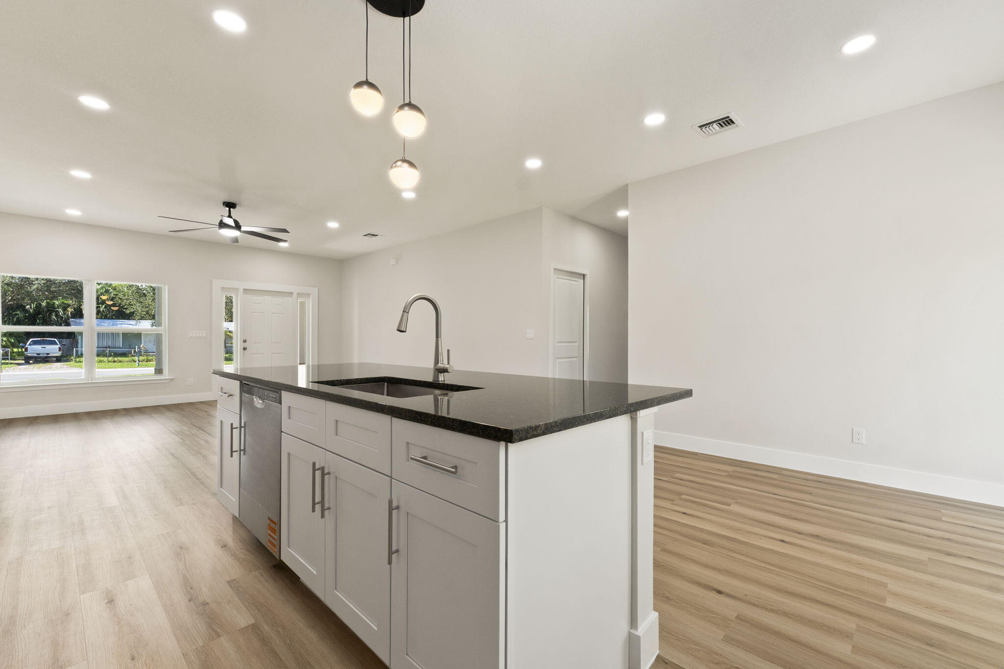 5310 Sunset Boulevard Fort Pierce, FL 34982 - Photo 15 of 39 a kitchen with stainless steel appliances granite countertop a sink and a wooden floors