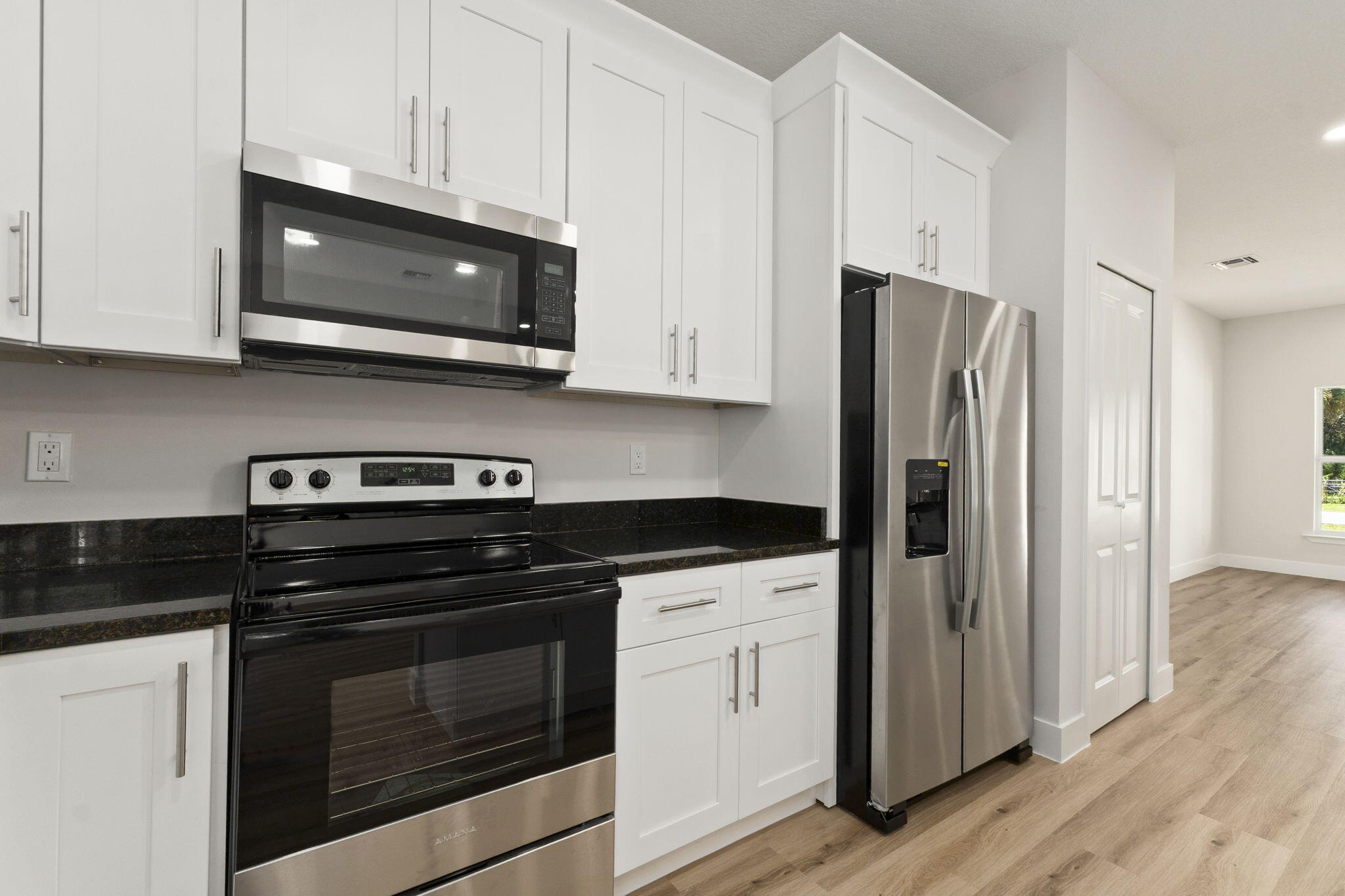 5310 Sunset Boulevard Fort Pierce, FL 34982 - Photo 17 of 39 a kitchen with stainless steel appliances granite countertop a stove a microwave and a refrigerator