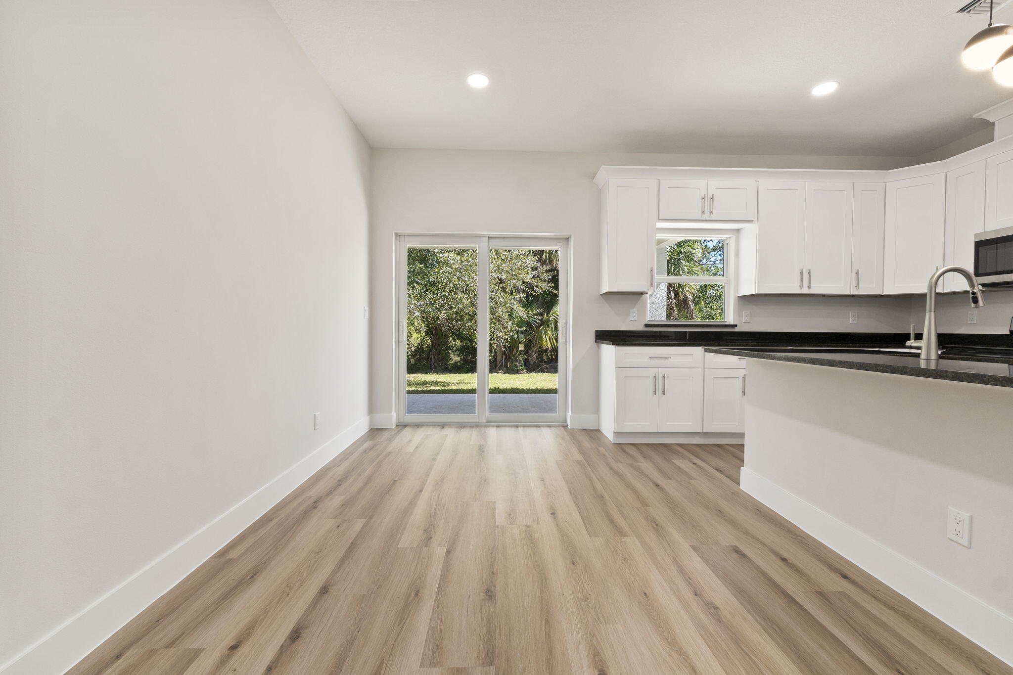 5310 Sunset Boulevard Fort Pierce, FL 34982 - Photo 19 of 39 a view of a kitchen with wooden floor and electronic appliances