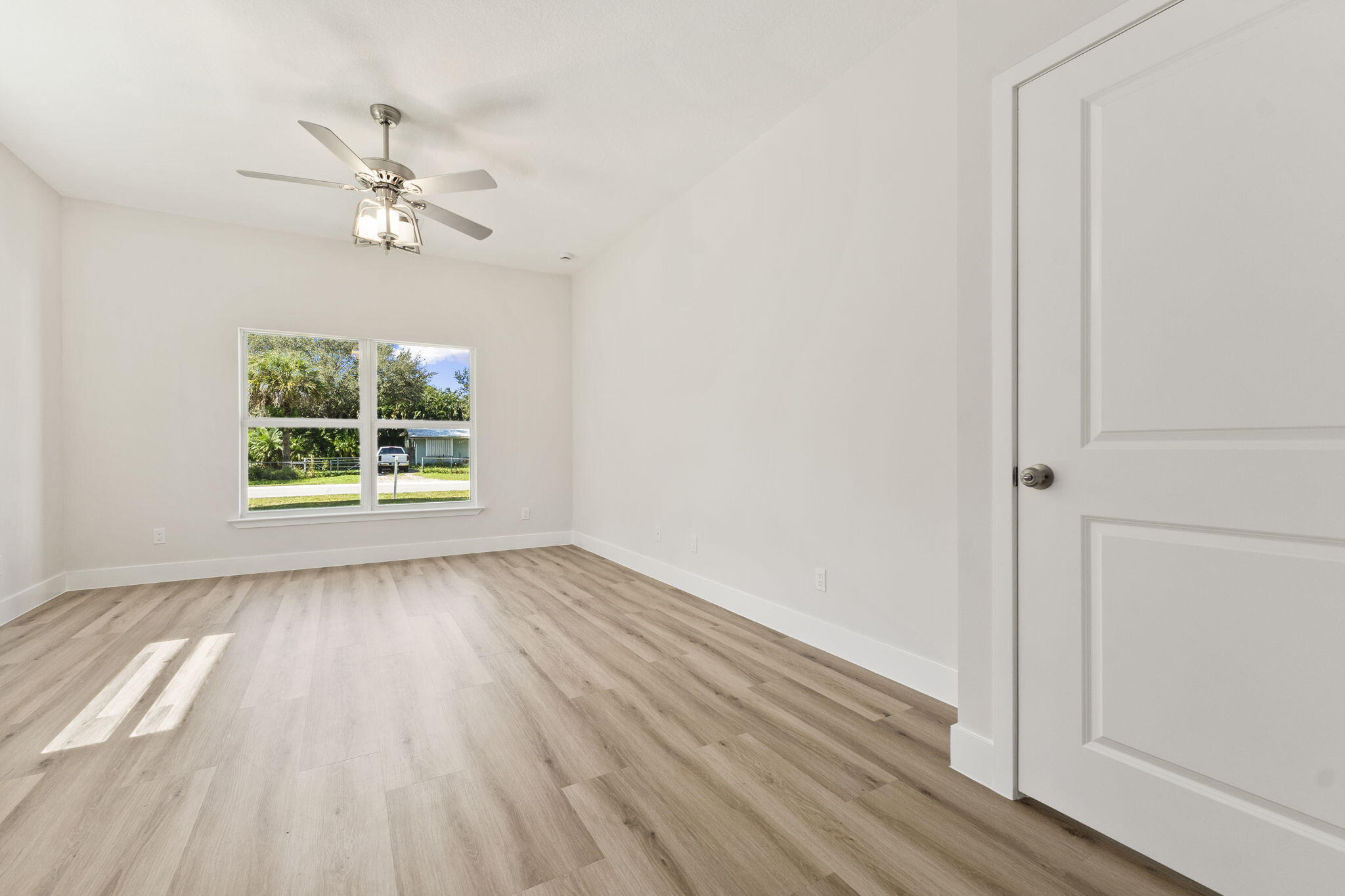 5310 Sunset Boulevard Fort Pierce, FL 34982 - Photo 21 of 39 a view of an empty room with wooden floor and a window