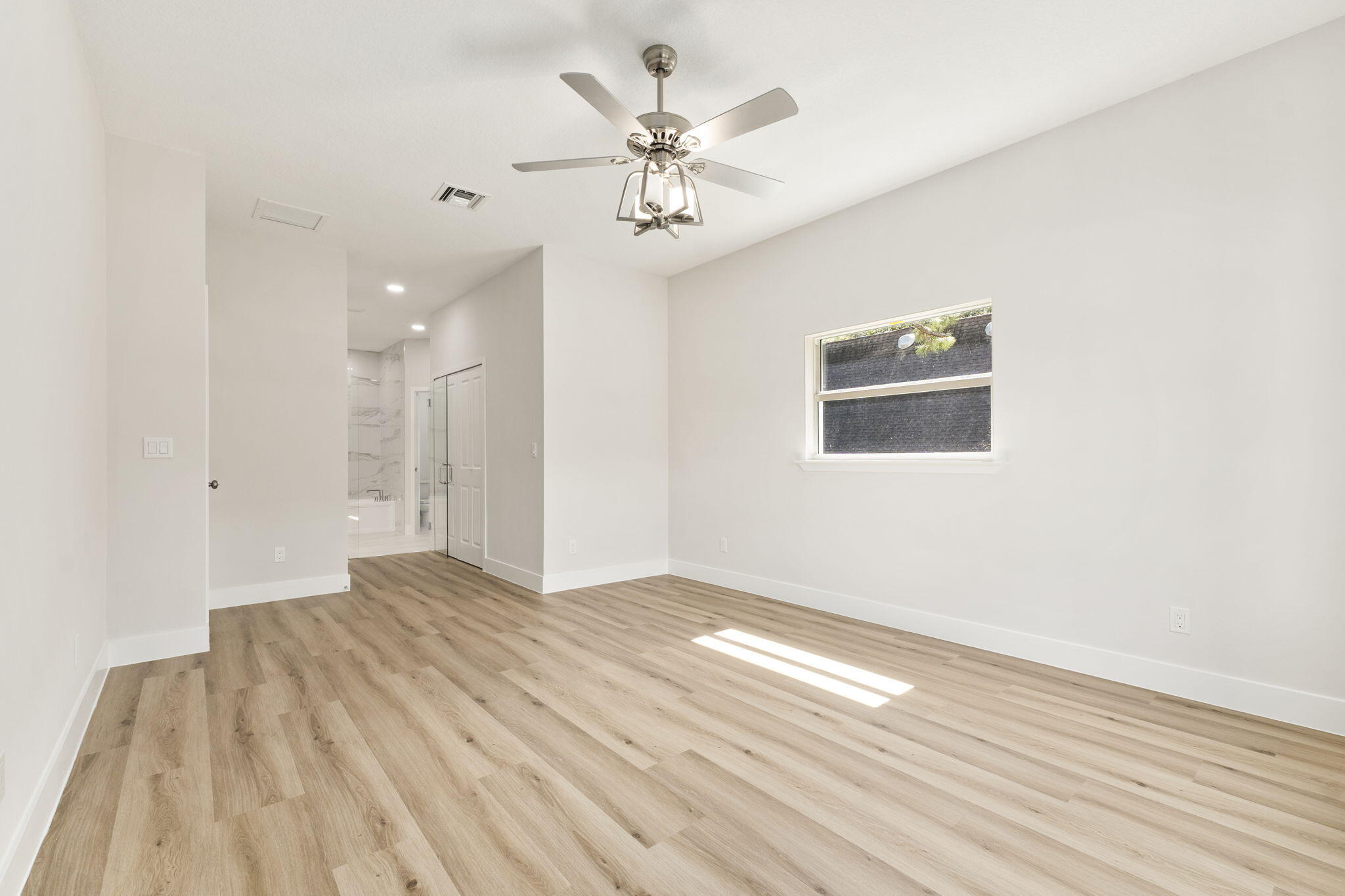 5310 Sunset Boulevard Fort Pierce, FL 34982 - Photo 22 of 39 wooden floor in an empty room with a window