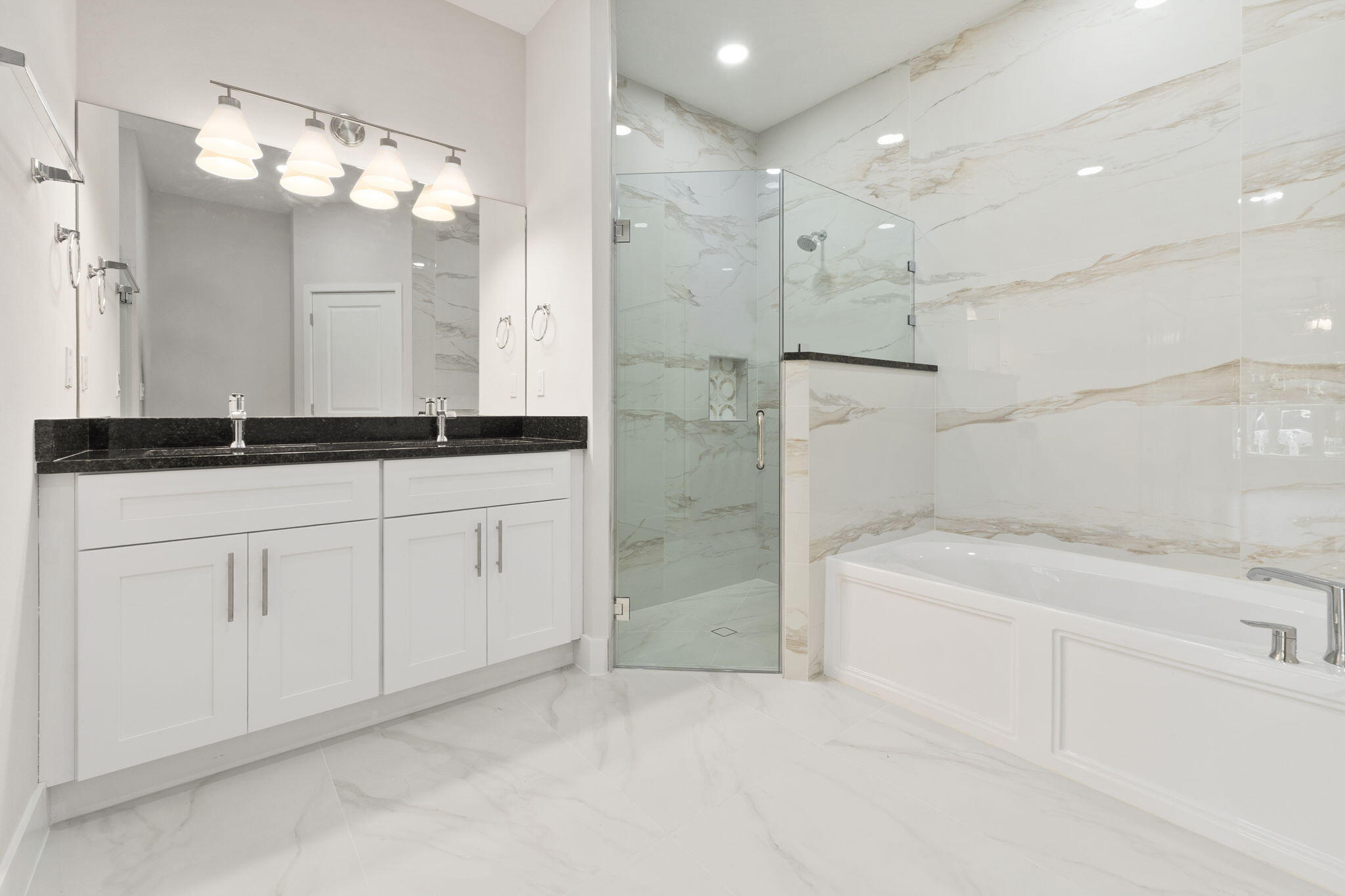5310 Sunset Boulevard Fort Pierce, FL 34982 - Photo 26 of 39 a spacious bathroom with a granite countertop sink a mirror a shower and a bathtub