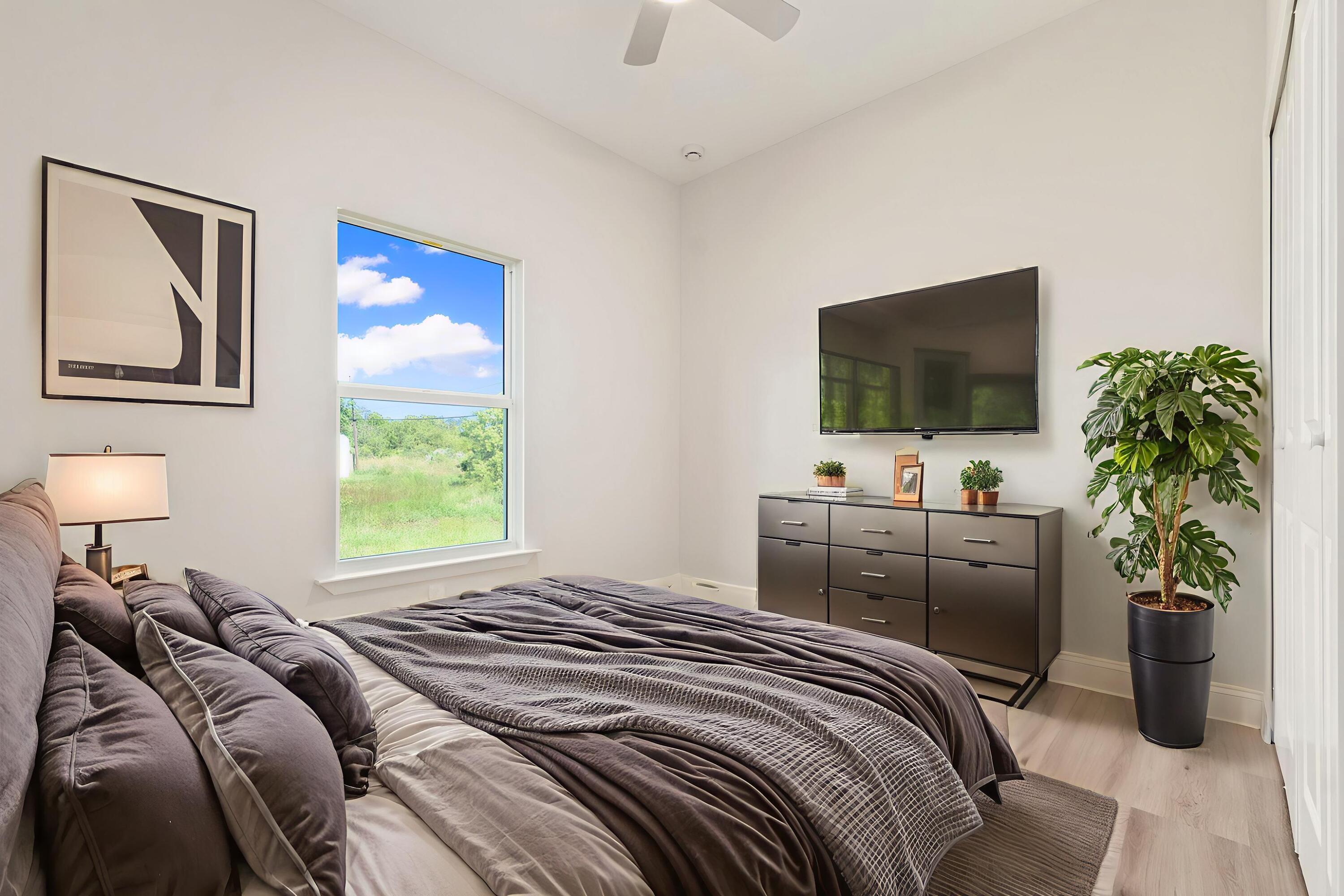 5310 Sunset Boulevard Fort Pierce, FL 34982 - Photo 31 of 39 a bedroom with a bed and a flat screen tv