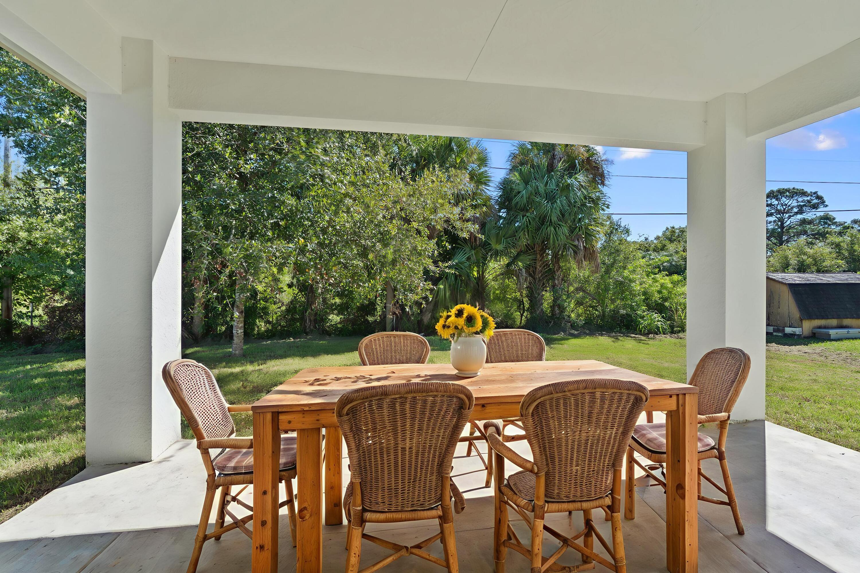 5310 Sunset Boulevard Fort Pierce, FL 34982 - Photo 34 of 39 a view of a dining table and chairs in the patio