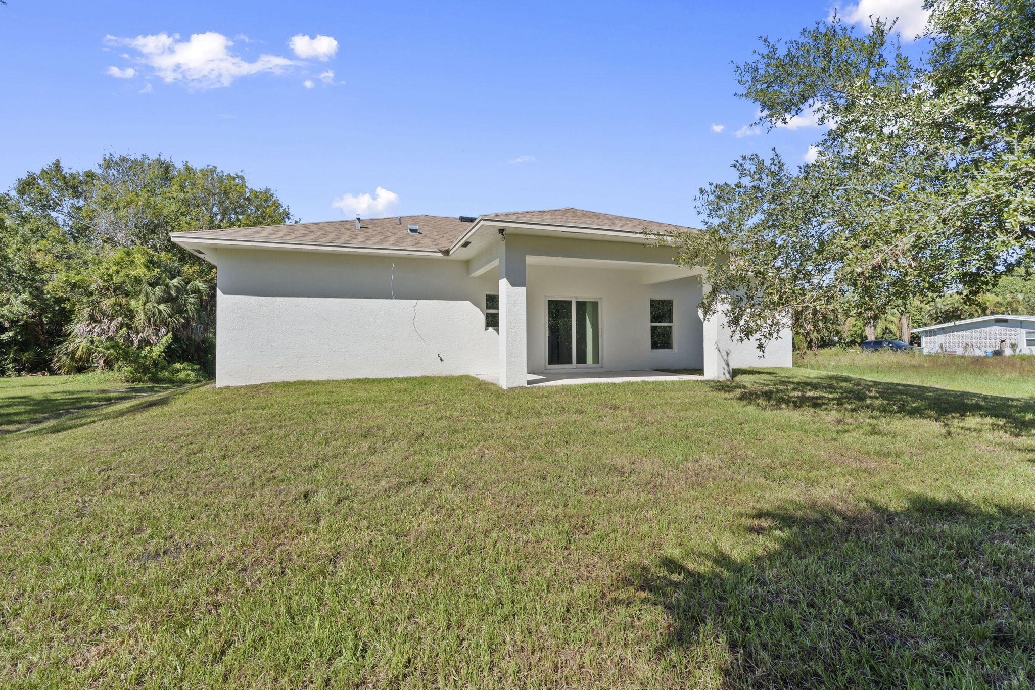 5310 Sunset Boulevard Fort Pierce, FL 34982 - Photo 38 of 39 a front view of a house with a yard and garage