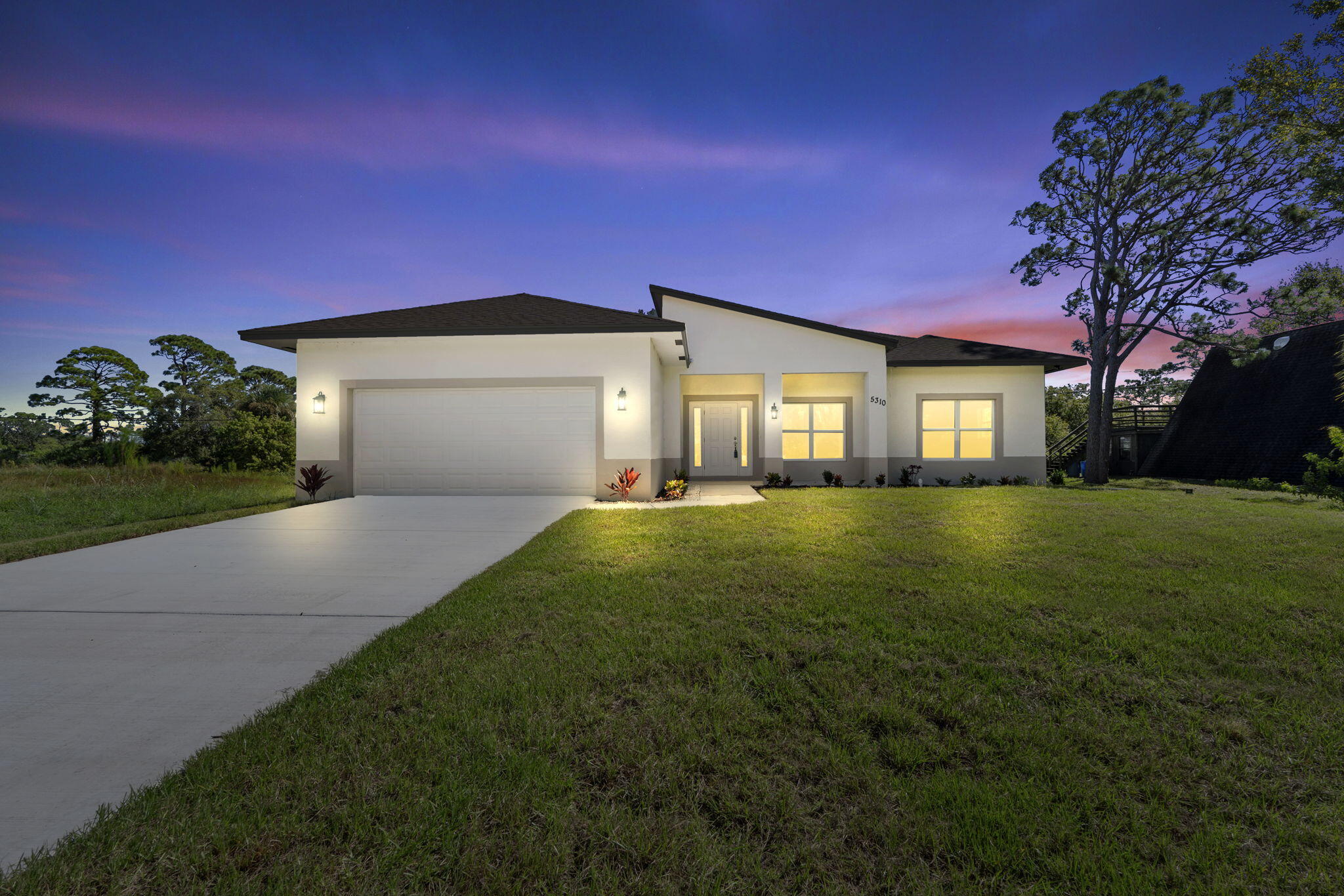 5310 Sunset Boulevard Fort Pierce, FL 34982 - Photo 7 of 39 a front view of a house with a yard and garage