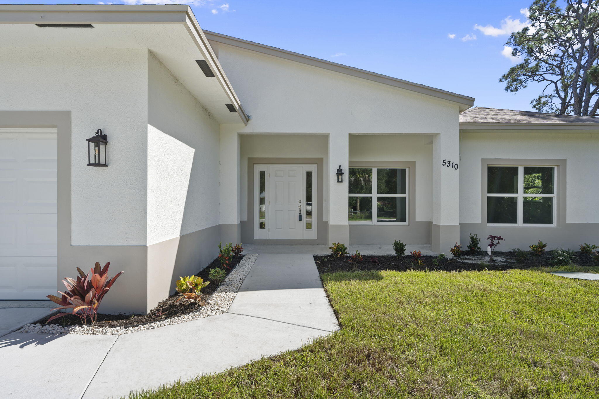 5310 Sunset Boulevard Fort Pierce, FL 34982 - Photo 9 of 39 a front view of a house with a garden