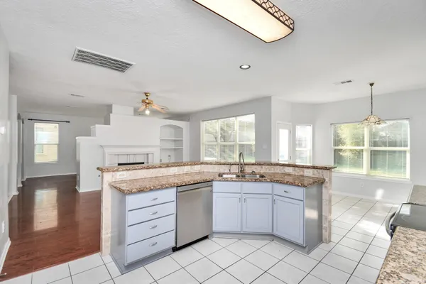 a kitchen with a stove a sink and a refrigerator