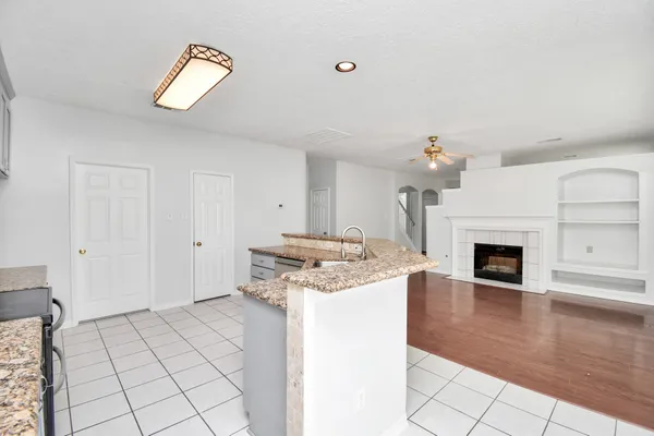 a open kitchen with a stove and a fireplace