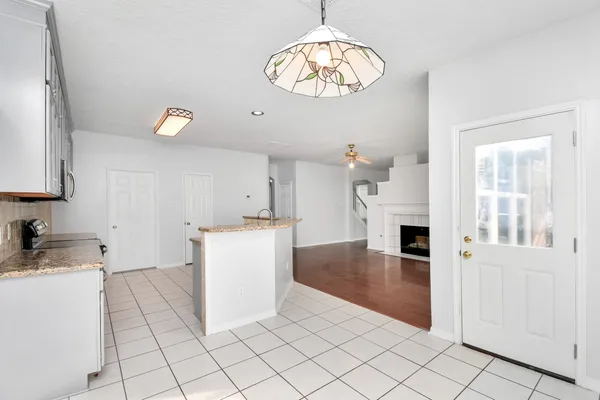 a kitchen with cabinets and window