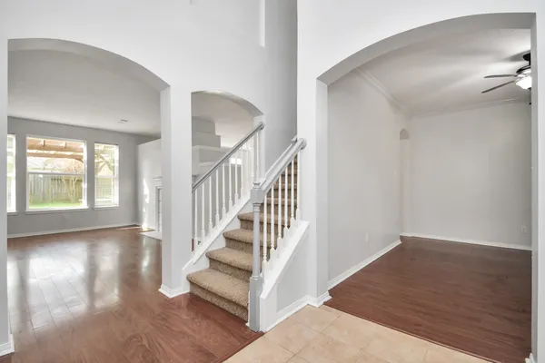 a view of entryway and hall with wooden floor