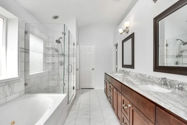 a bathroom with a granite countertop tub sink double vanity granite tub and shower
